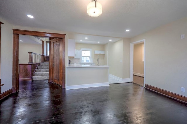 unfurnished living room featuring dark wood-type flooring