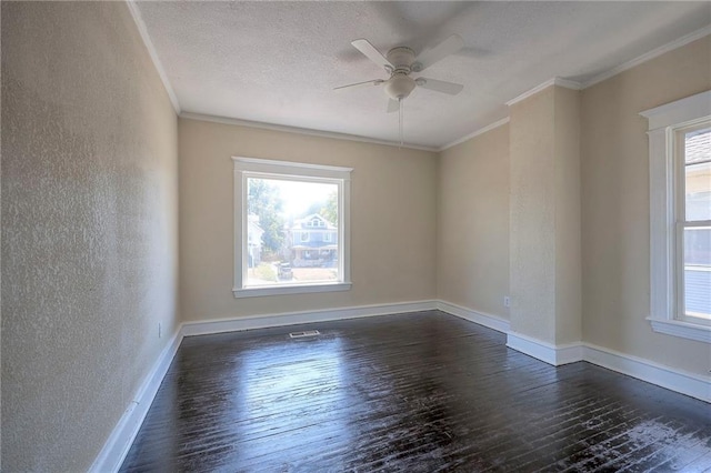 spare room featuring plenty of natural light, ceiling fan, and dark hardwood / wood-style flooring