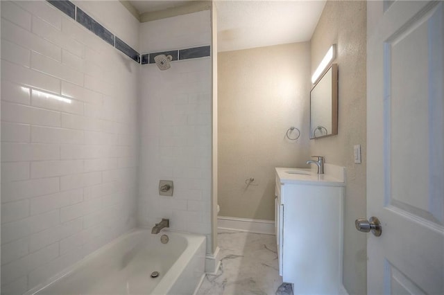 full bathroom with tiled shower / bath, toilet, and vanity