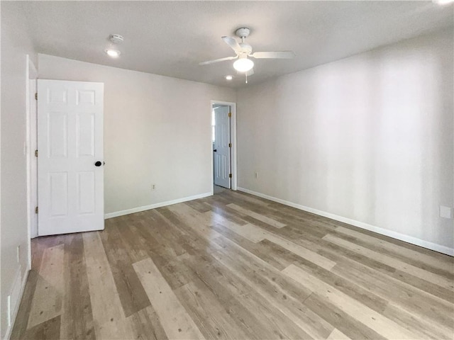 spare room with light hardwood / wood-style flooring and ceiling fan