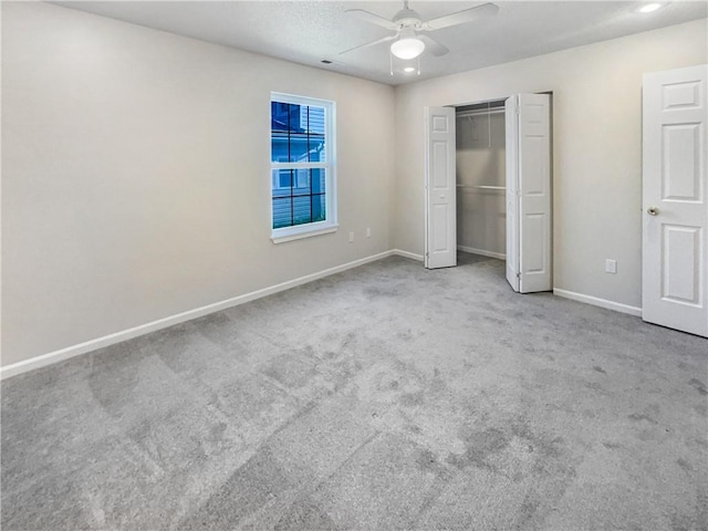 unfurnished bedroom with light colored carpet, ceiling fan, and a closet