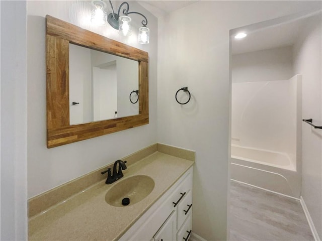 bathroom with vanity, hardwood / wood-style floors, and shower / bath combination