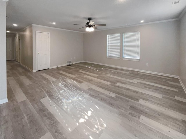 spare room featuring crown molding, light hardwood / wood-style flooring, and ceiling fan