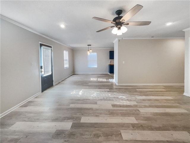 interior space featuring light wood-type flooring, ceiling fan, and ornamental molding