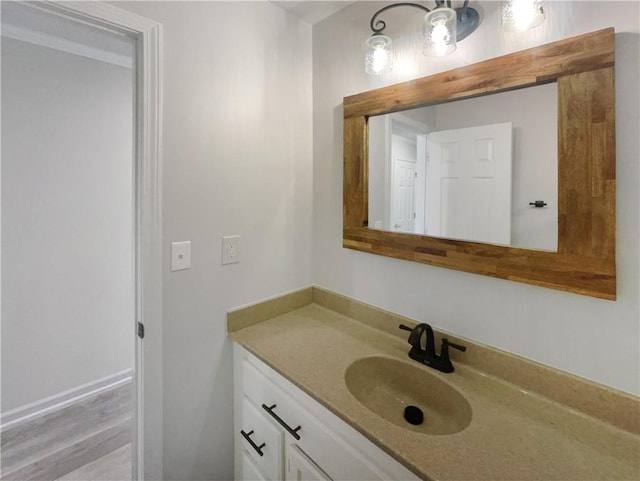 bathroom with hardwood / wood-style floors and vanity