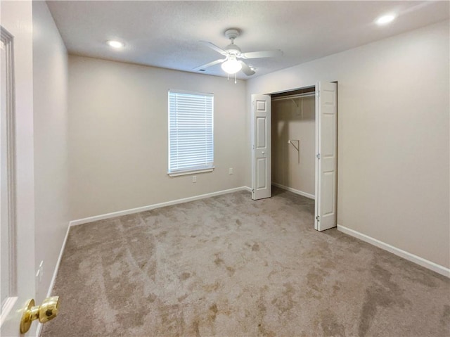 unfurnished bedroom with a closet, ceiling fan, and light colored carpet