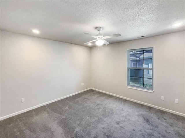 carpeted spare room featuring a textured ceiling and ceiling fan