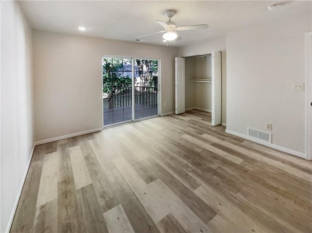 unfurnished bedroom featuring a closet, ceiling fan, access to exterior, and light hardwood / wood-style flooring