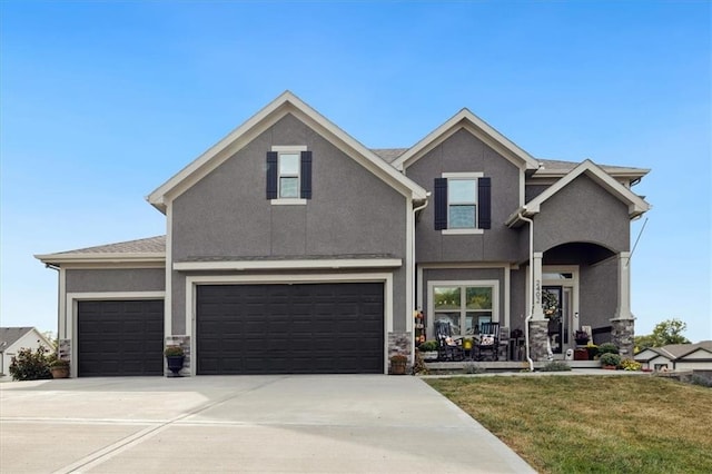 view of front of home with a front yard and a garage