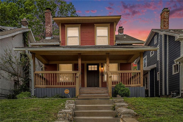 view of front facade featuring a yard and covered porch