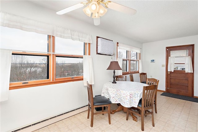 dining space with tile patterned floors, baseboard heating, ceiling fan, and a textured ceiling