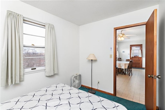 bedroom with baseboards and multiple windows