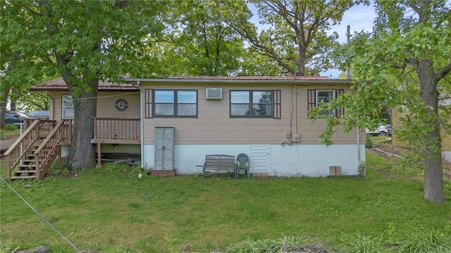 back of property with a lawn, stairs, and a wooden deck