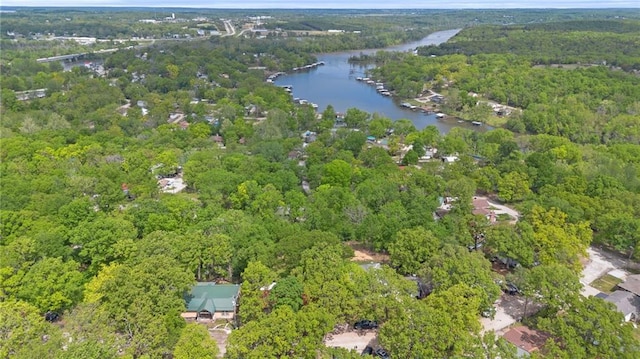 aerial view with a water view and a forest view