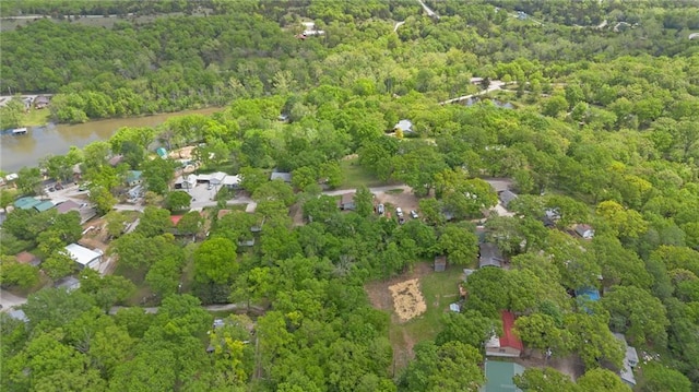drone / aerial view with a water view and a wooded view