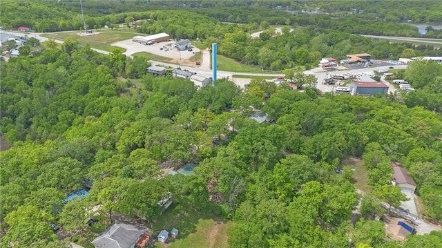 birds eye view of property with a view of trees