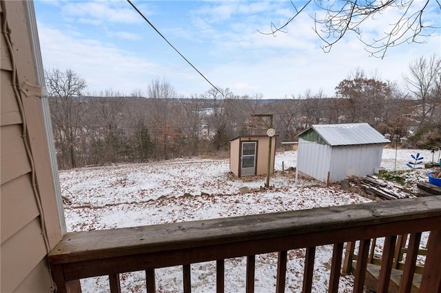 snowy yard with a storage unit