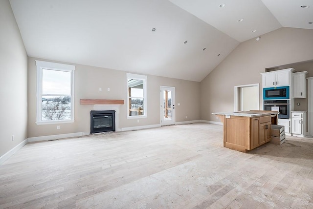 unfurnished living room featuring vaulted ceiling