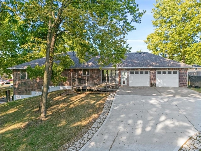 ranch-style home featuring a garage and a front yard