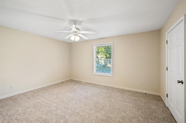 unfurnished bedroom with a textured ceiling, ceiling fan, and carpet