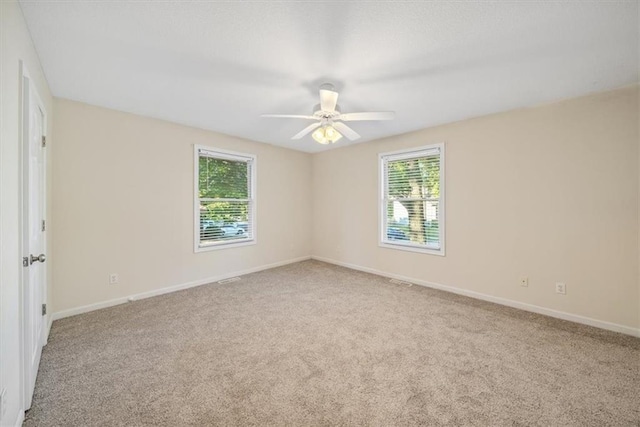 empty room with light colored carpet and ceiling fan