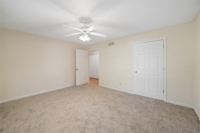 unfurnished bedroom featuring ceiling fan and light carpet