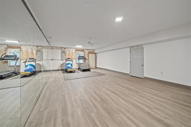 exercise area with plenty of natural light, ceiling fan, and light hardwood / wood-style flooring