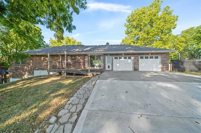 single story home featuring a front lawn and a garage