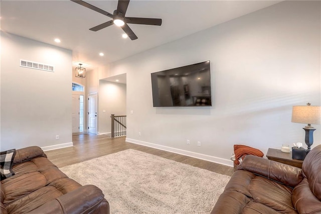 living room featuring ceiling fan and hardwood / wood-style flooring