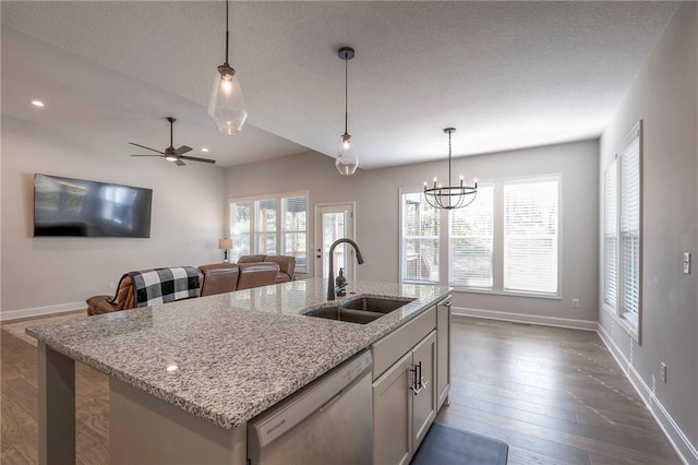 kitchen featuring decorative light fixtures, dishwasher, sink, and a wealth of natural light