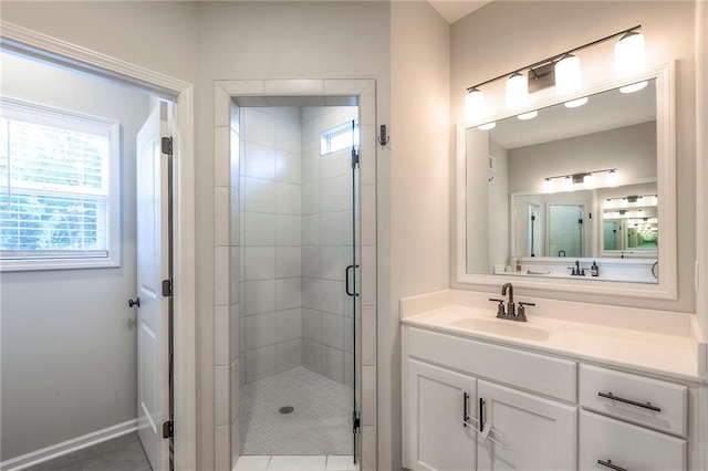 bathroom with walk in shower, vanity, and tile patterned floors