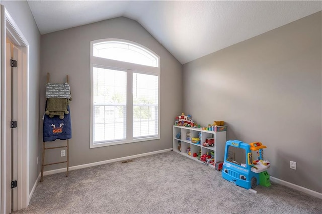 playroom featuring light carpet and lofted ceiling