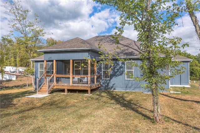 back of house with a sunroom and a yard