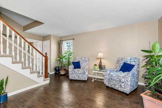 sitting room with dark hardwood / wood-style flooring and a textured ceiling