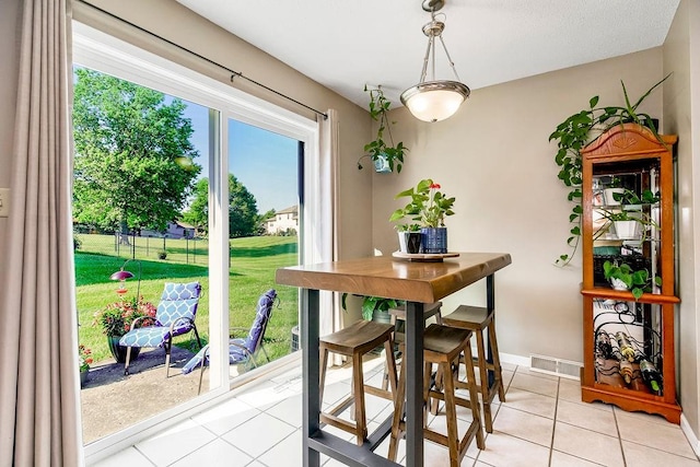 dining area with light tile patterned floors