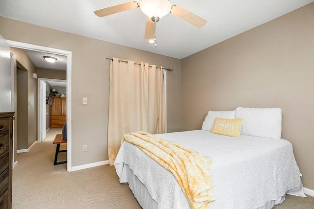 bedroom with ceiling fan and light carpet