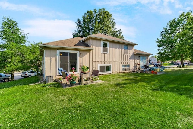 rear view of house featuring a yard, a patio area, and central air condition unit