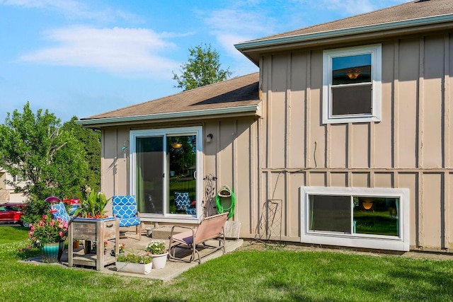 rear view of property with a lawn