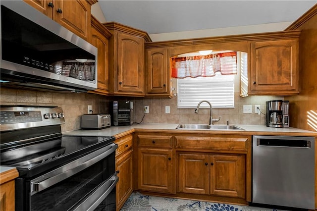 kitchen featuring backsplash, stainless steel appliances, and sink