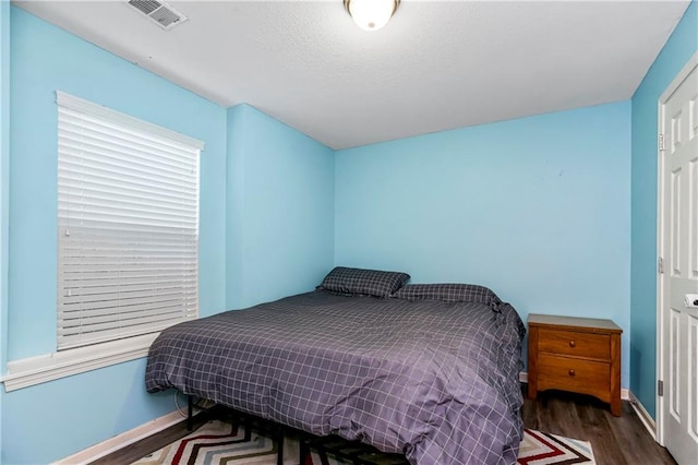 bedroom with dark wood-type flooring