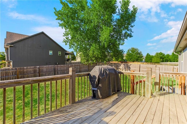 deck featuring area for grilling and a yard