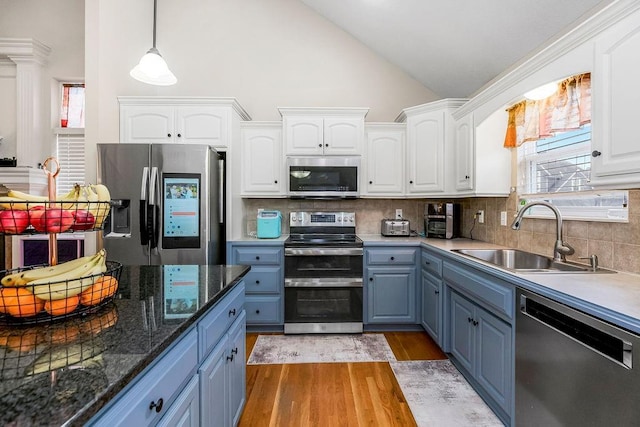 8500 NE 99th Ter, Kansas City, MO 64157 - kitchen with pendant lighting, sink, white cabinets, and appliances with stainless steel finishes