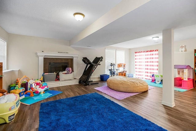 8500 NE 99th Ter, Kansas City, MO 64157 - recreation room with hardwood / wood-style floors, a textured ceiling, and a fireplace