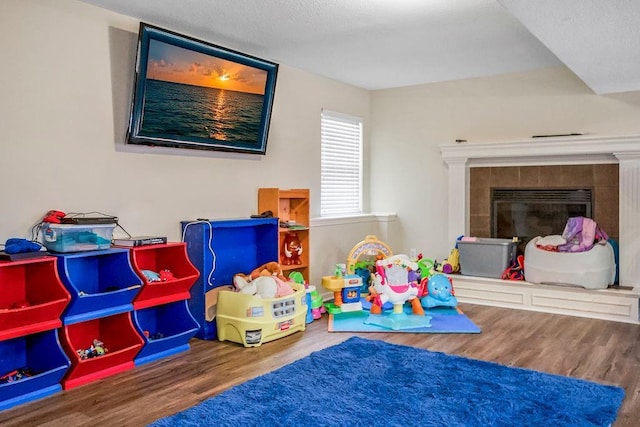8500 NE 99th Ter, Kansas City, MO 64157 - rec room featuring hardwood / wood-style flooring and a fireplace
