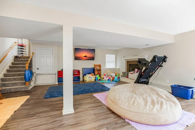 8500 NE 99th Ter, Kansas City, MO 64157 - playroom with hardwood / wood-style flooring and a tile fireplace