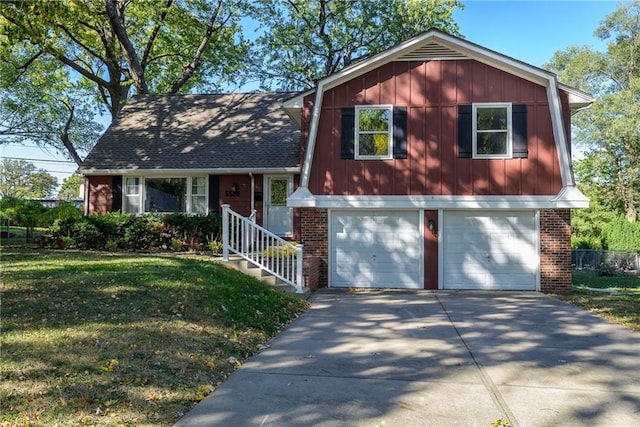 split level home featuring a garage and a front lawn