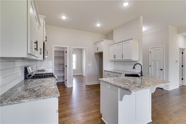 kitchen featuring dark hardwood / wood-style flooring, sink, white cabinets, and stainless steel appliances