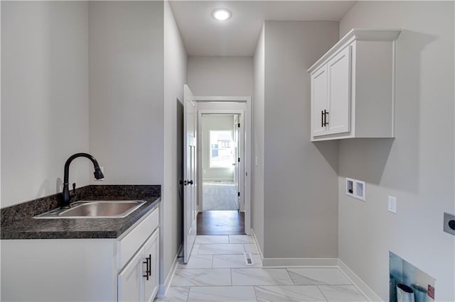 washroom featuring hookup for an electric dryer, sink, cabinets, and washer hookup