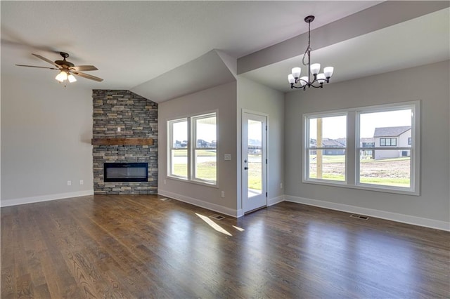 unfurnished living room featuring vaulted ceiling, a fireplace, a healthy amount of sunlight, and dark hardwood / wood-style floors