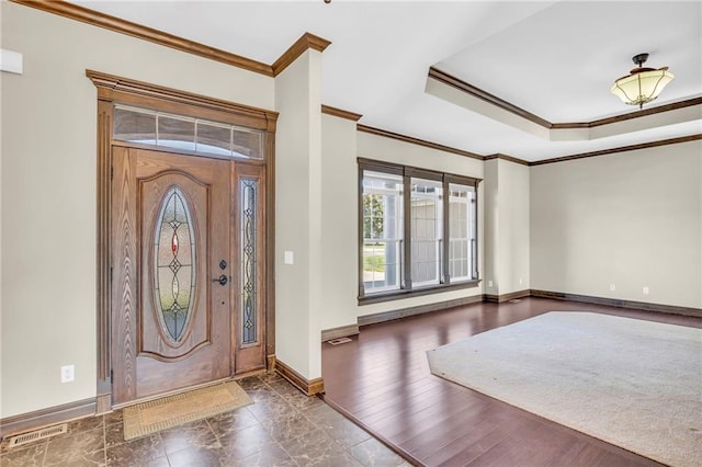 foyer with dark wood-type flooring and crown molding